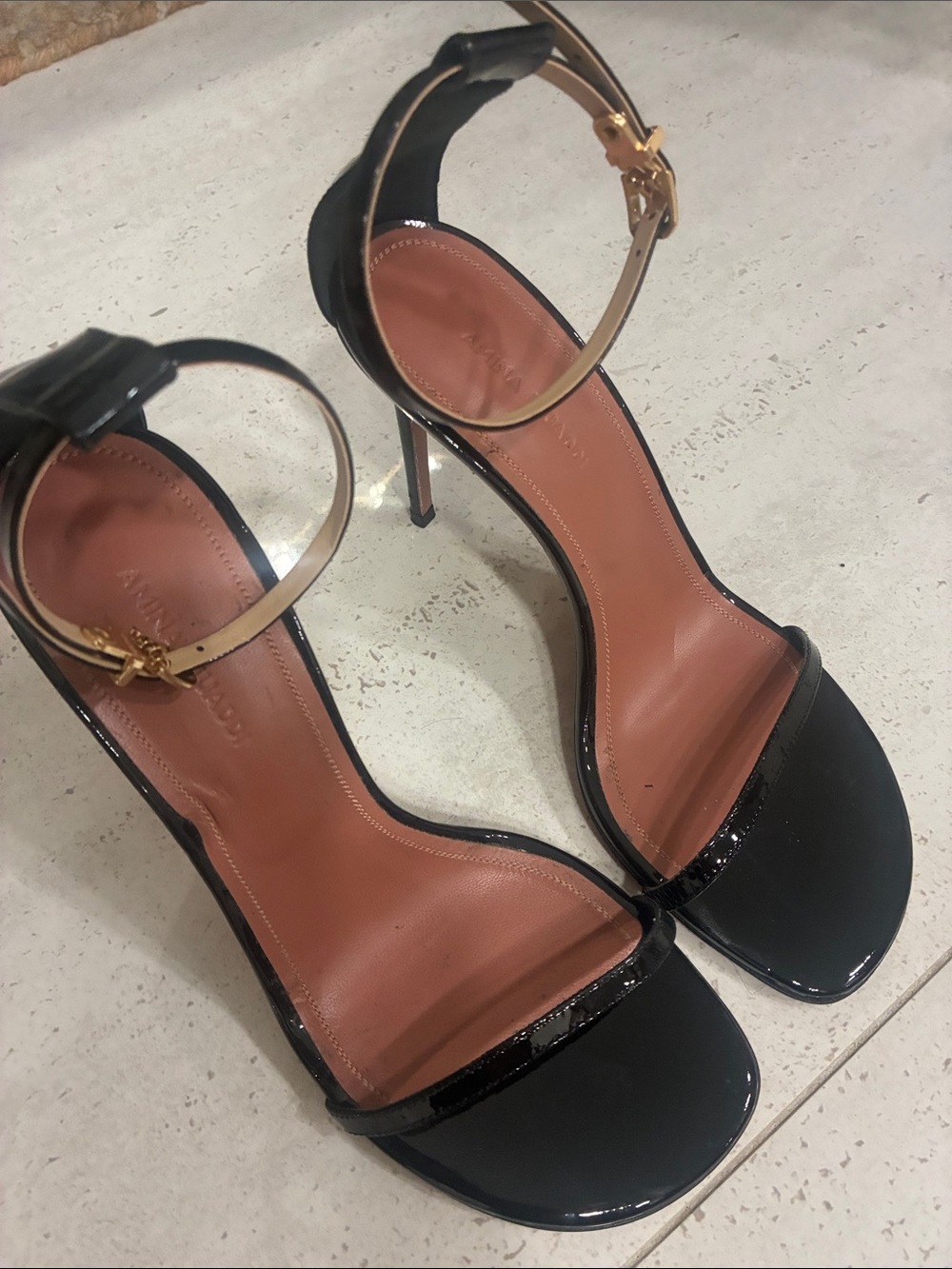 Amina Muaddi Black Patent Leather Ankle-Strap Stilettos with Gold Buckle